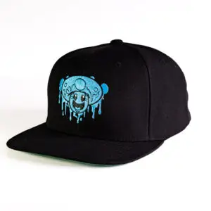 Black flat billed. snapback cap with embroidered One Up logo and blue mushroom smiley face on it.